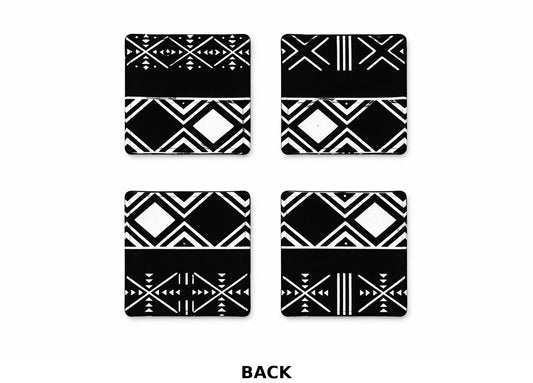Back side of set of four black and white fabric African geometric patterned coasters on a white background