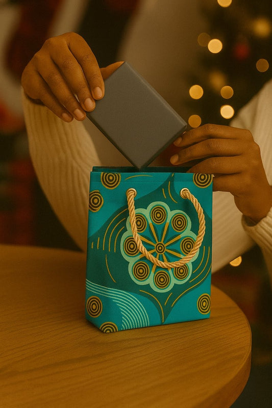 Green, dark green, & gold handmade African fabric mini gift bag in lifestyle shot