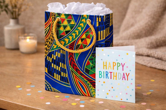 Royal blue, green, red, orange, yellow, black, & gold extra small gift bag with tissue paper and card on a celebratory background