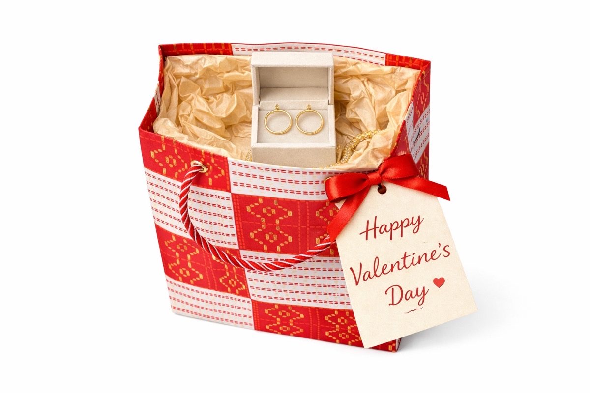 White, red, & gold mini gift bag with product ideas to gift inside on a white background