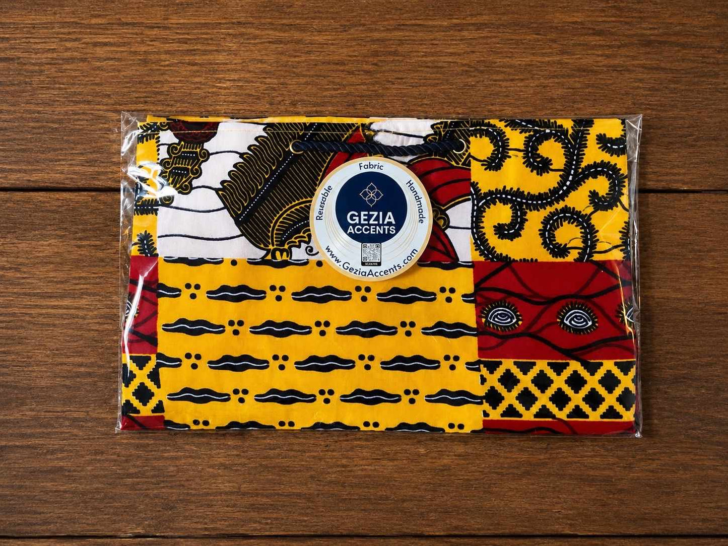 Packaged medium horizontal gift bag with geometric patterns on a wooden surface