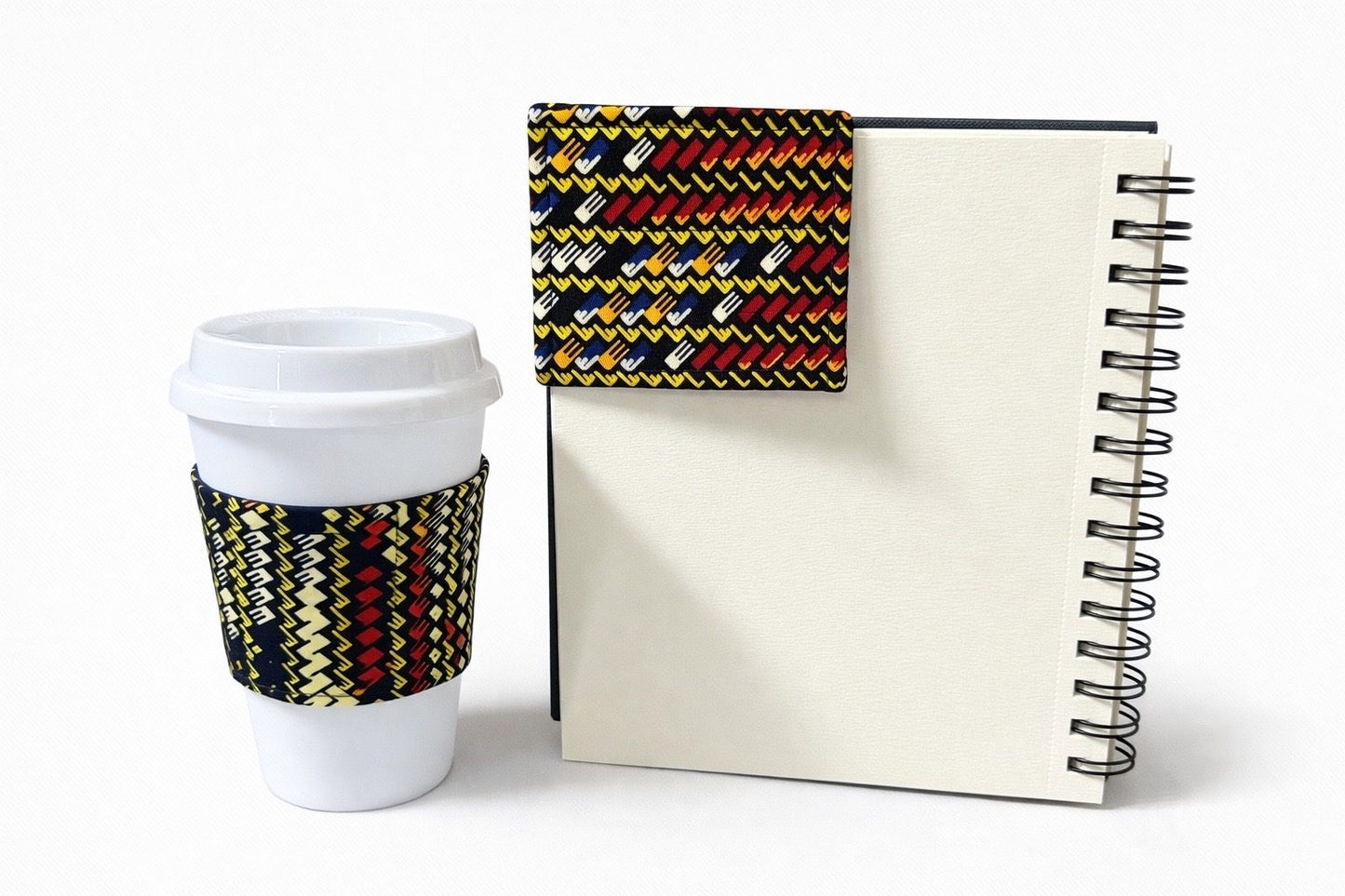 Red, blue, cream, & yellow cup sleeve & corner bookmark on a white background