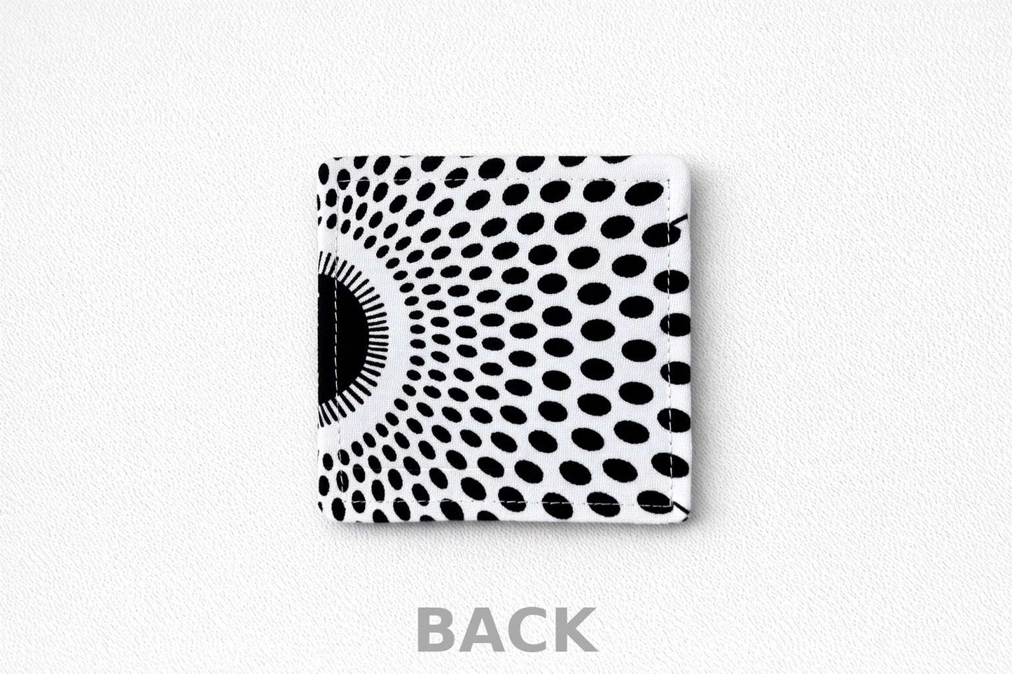 Black and white patterned corner bookmark on a light gray background