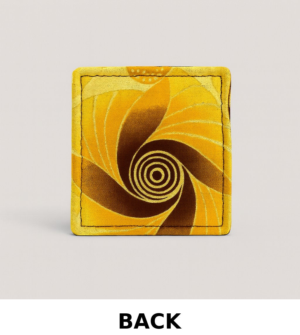 back view of yellow corner bookmark with brown, orange, & gold patterns on a light gray background