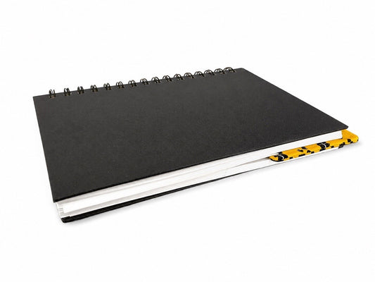 Black notebook with a corner bookmark in yellow accents on a gray background