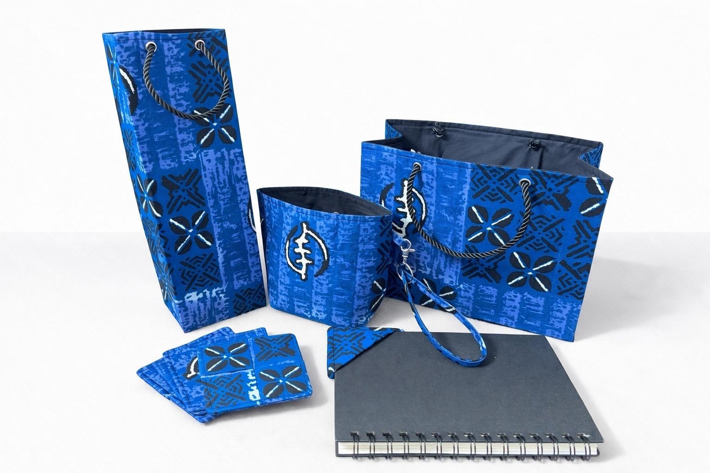 Blue, white, & black small horizontal bag, wine bag, coaster set, mini tote & corner bookmark on a white background