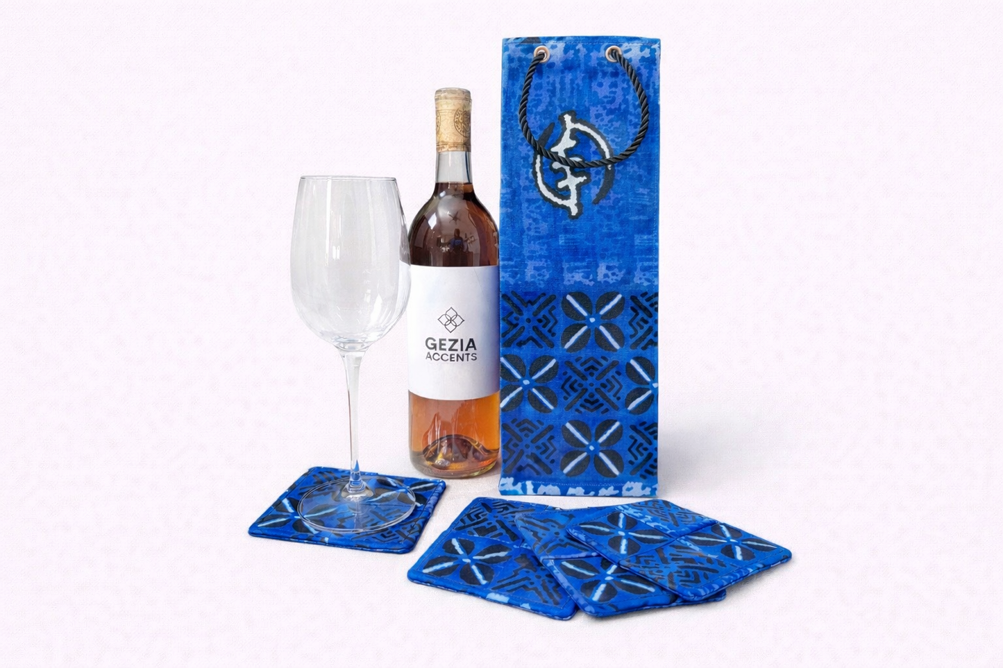 Blue, black, & white wine bag & four piece coaster set on a white background