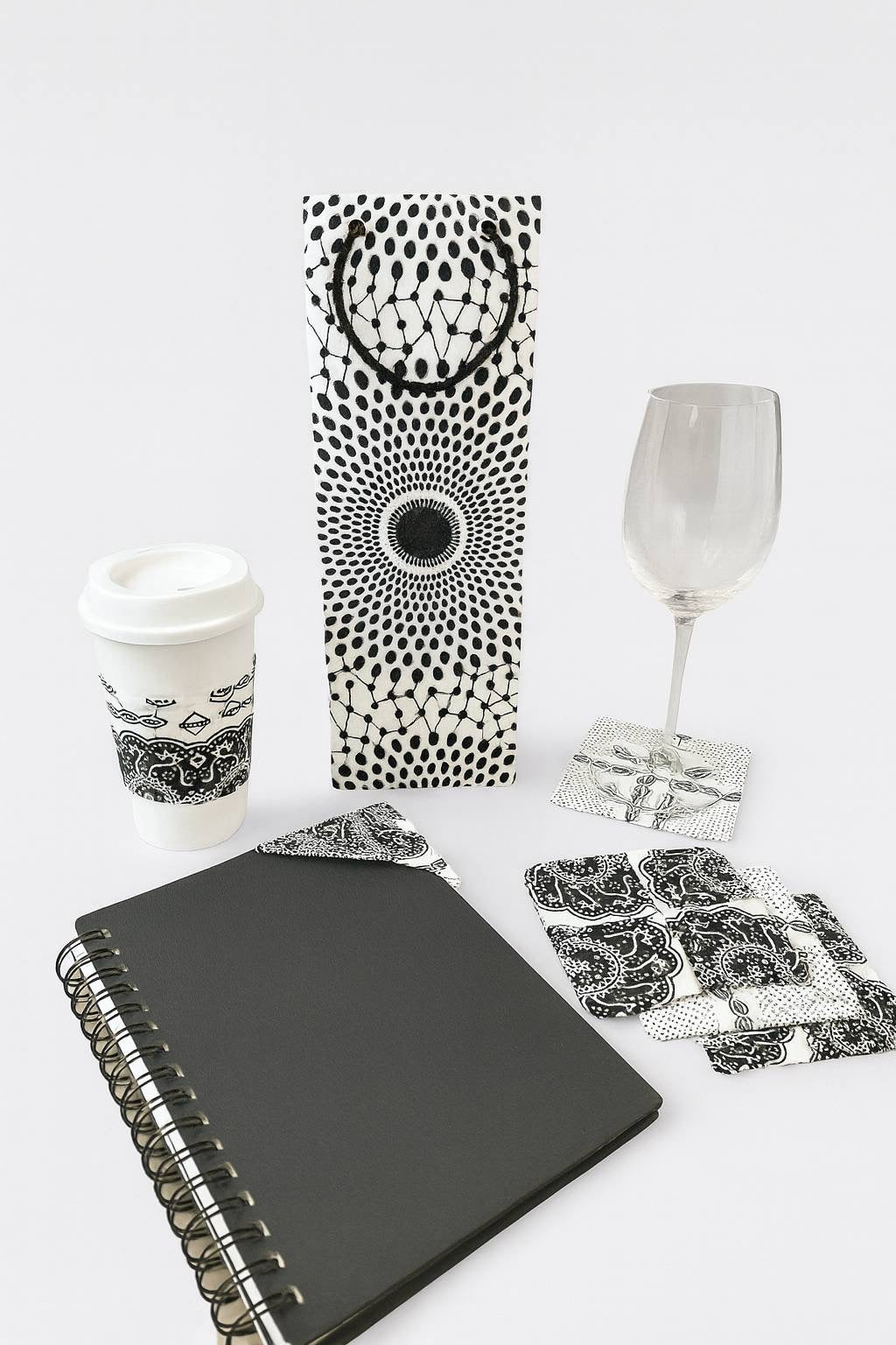 Cup sleeve, wine bag, corner bookmark, 4 piece coaster set on a white background