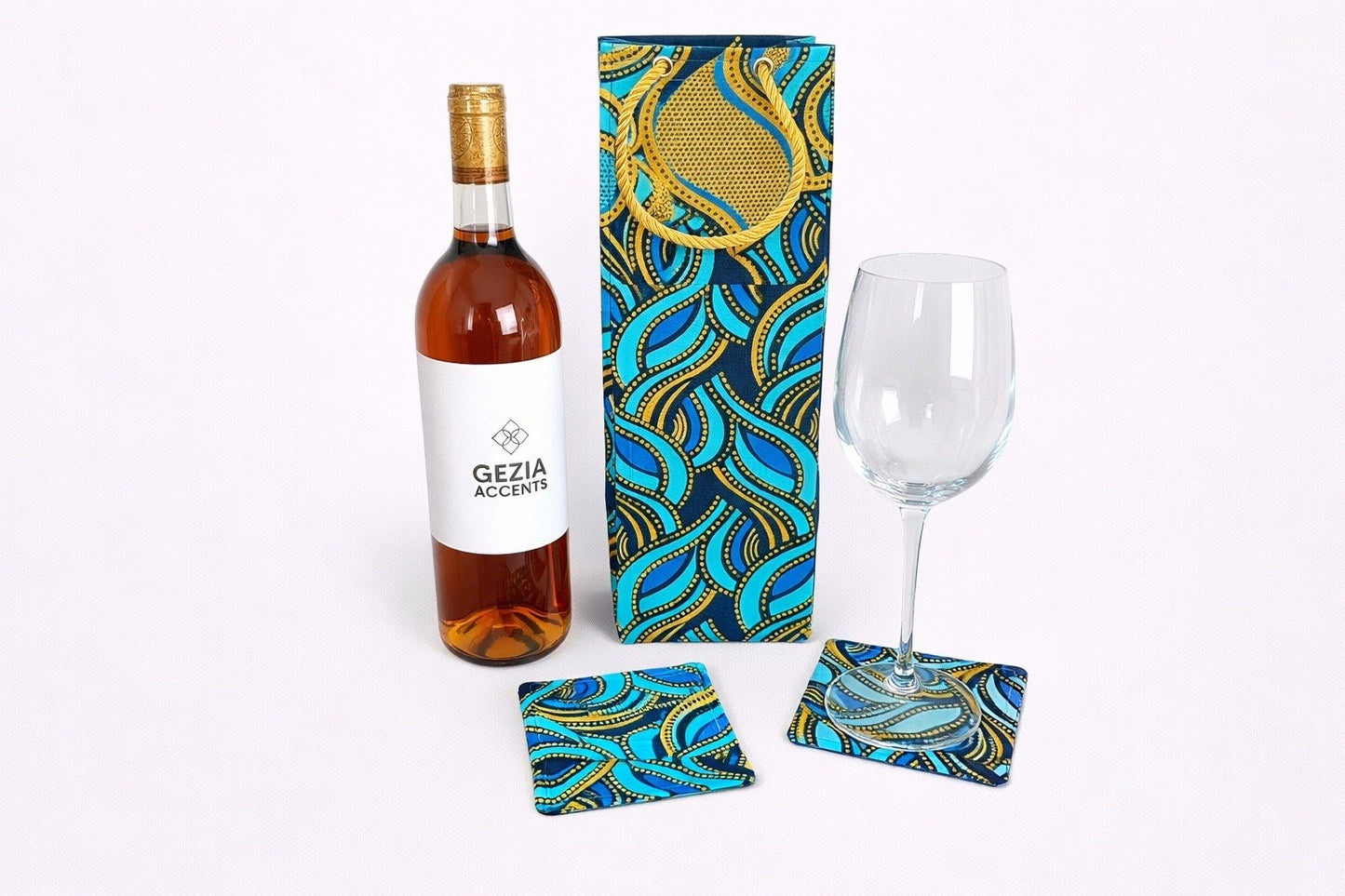Turquoise, dark blue, & gold wine bag & two coasters on a white background