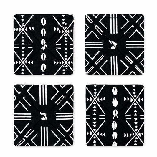 Four black and white African fabric patterned coasters on a white background