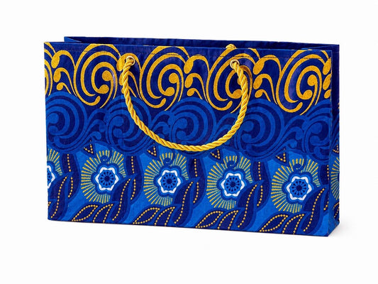 Decorative gift bag with blue, dark blue, white, and gold patterns on a white background