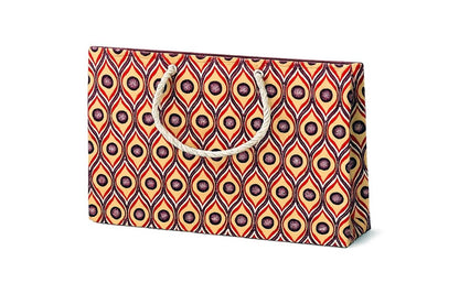 Cream, red, dark purple and white patterned gift bag with a handle on a white background