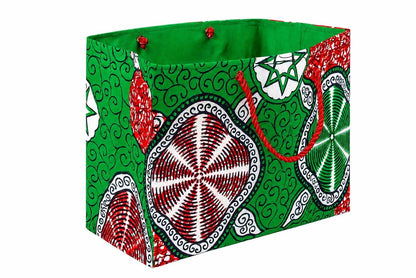 Side view of a colorful fabric red, white, and green gift bag with geometric patterns on a white background