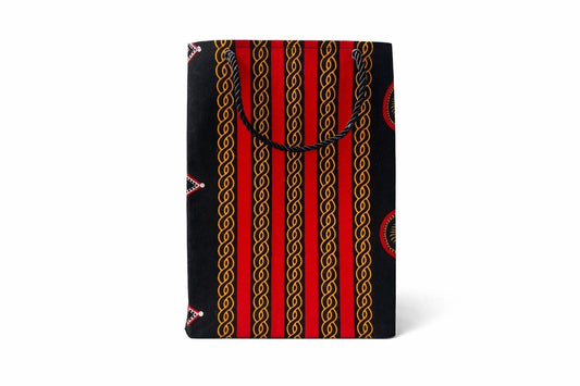 Black, gold, white and red patterned gift bag on a white background