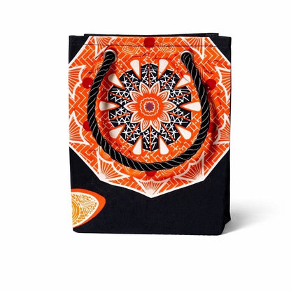Black decorative gift bag with orange and white pattern on a white background