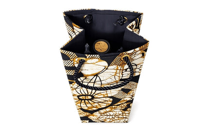 Inside view of a decorative cream, black, and gold wine bottle bag with floral pattern on a white background