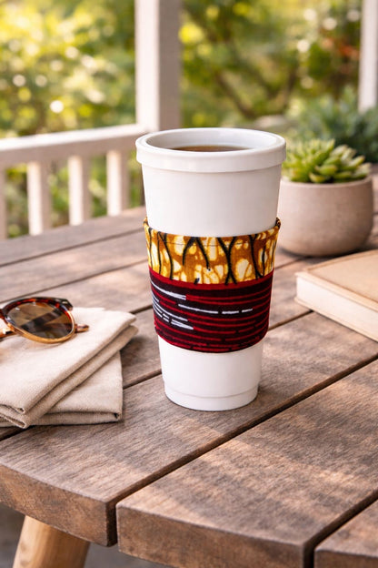Cream, dark blue, red, brown, & white handmade African fabric cup sleeve lifestyle shot