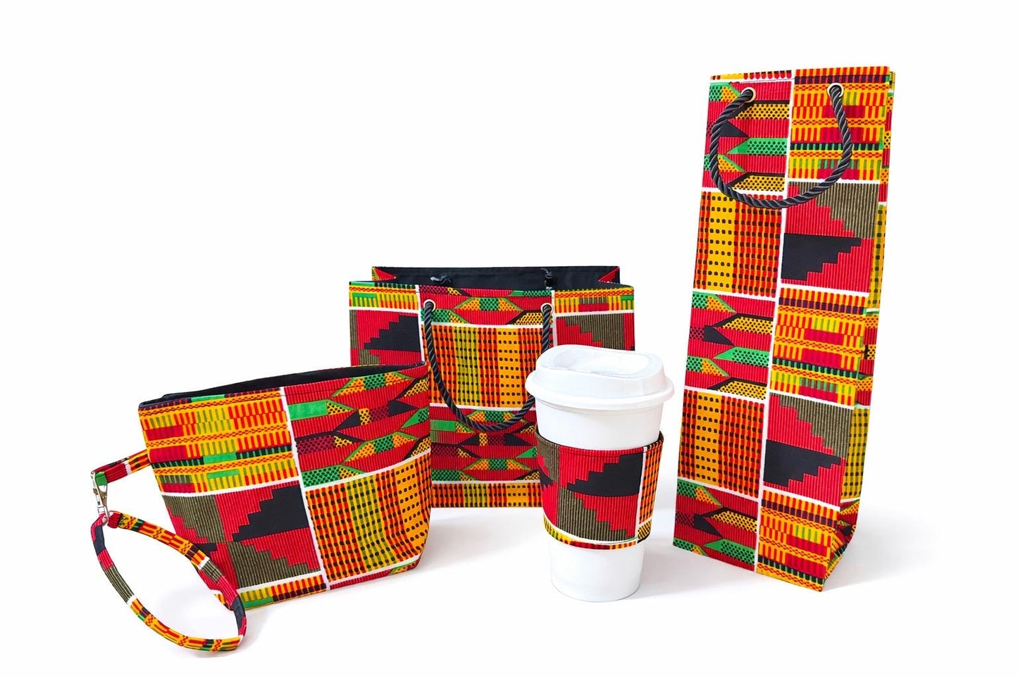 Orange, red, green, black, & white wine bag, mini tote, small horizontal bag, & cup sleeve on a white background