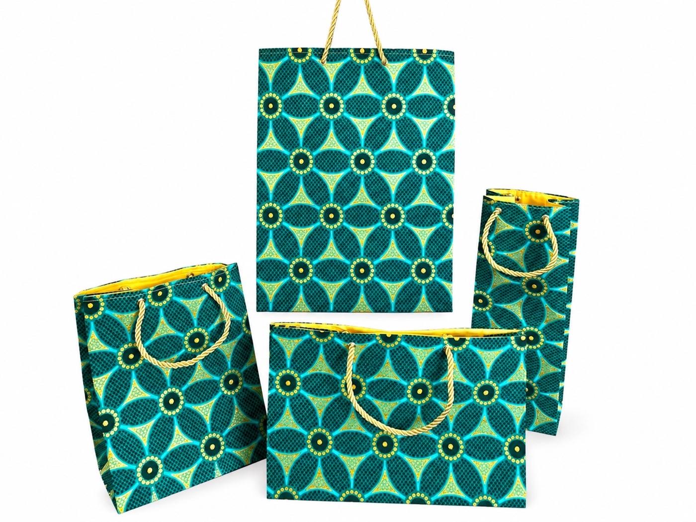 Set of four green, dark green, and gold patterned bags with gold handles on a white background