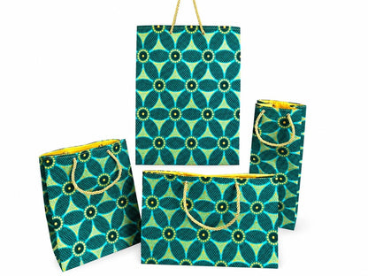 Set of four green, dark green, and gold patterned bags with gold handles on a white background