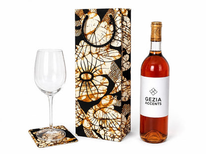Wine bottle, glass, and coaster set with decorative box on a white background