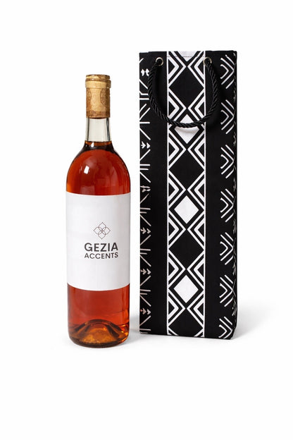 Bottle of wine with a black and white wine gift bag on a white background