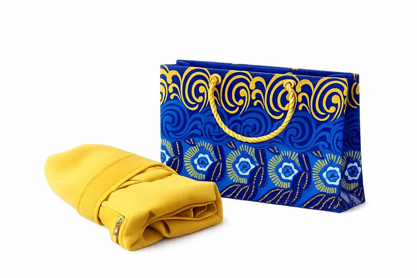 Yellow garment in front of a blue, dark blue, white, and gold patterned gift bag on a white background