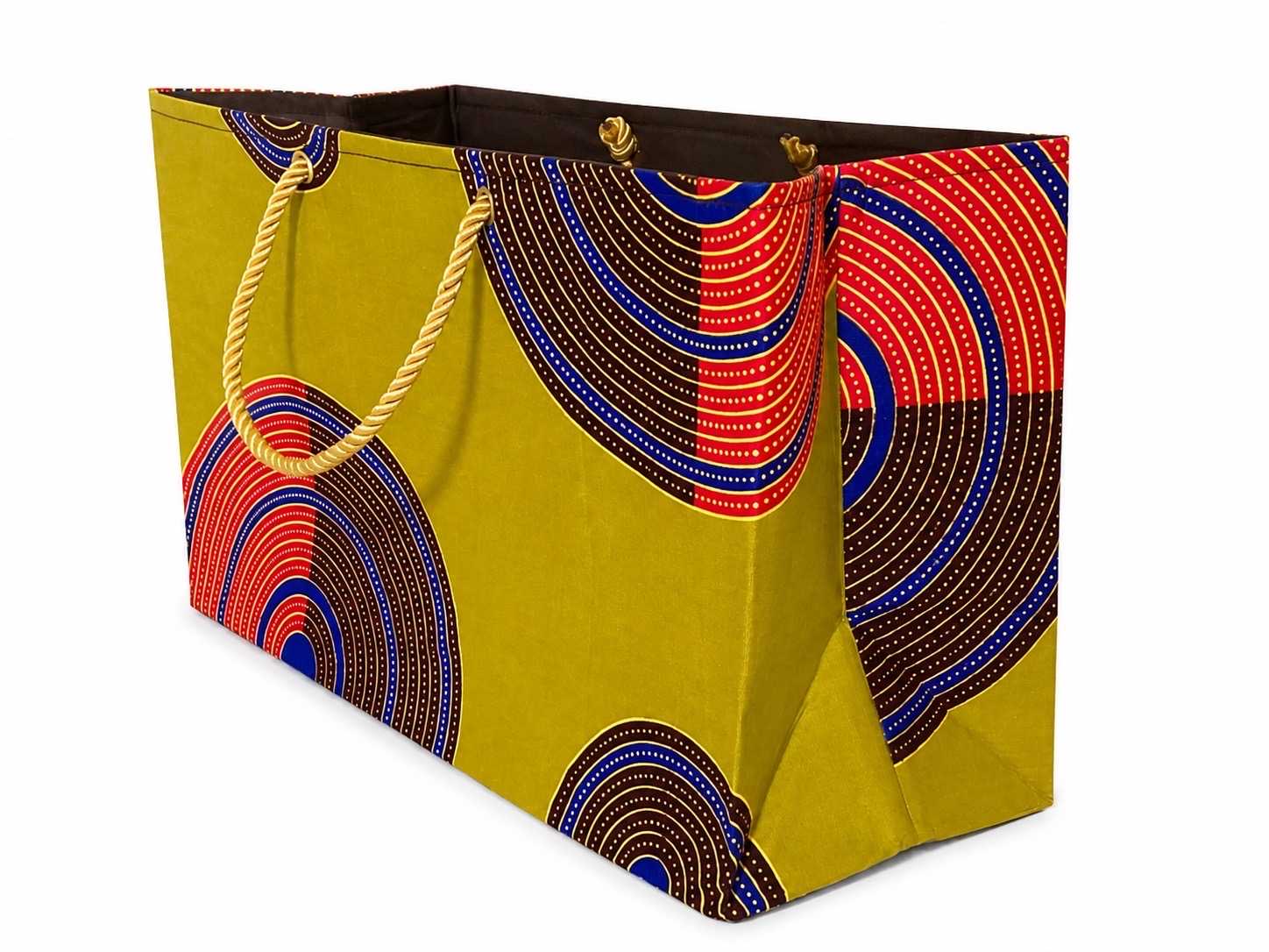 Side view of a decorative gift bag with green, dark brown, red, blue, and gold pattern on a white background
