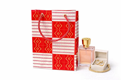 Red, white, & gold extra small gift bag with product ideas to gift on the side on a white background
