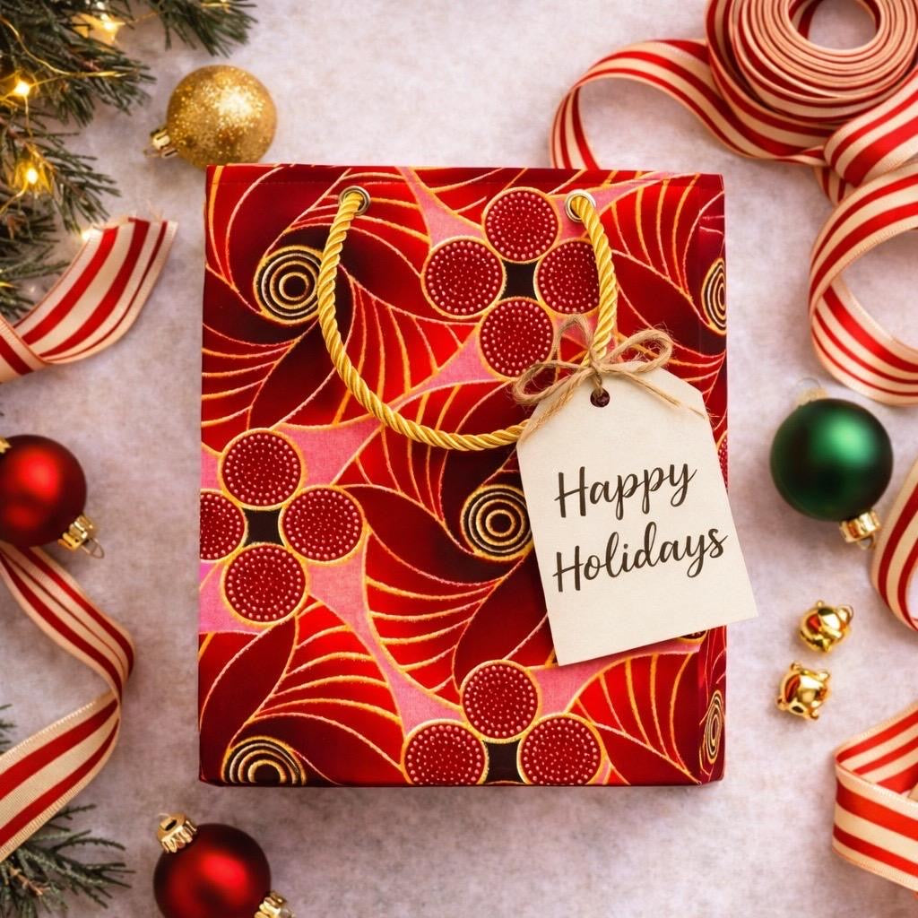 Red, maroon, pink, & gold handmade African fabric extra small gift bag in holiday lifestyle shot