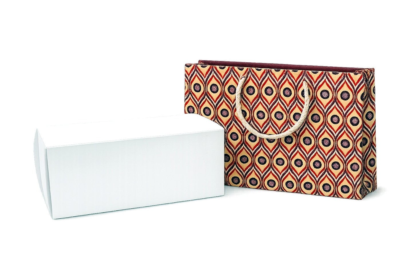 Cream, red, deep purple, and white patterned gift bag with a white box on a white background