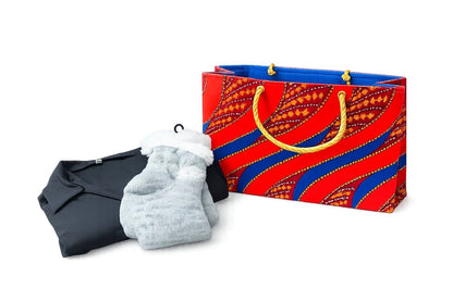 Colorful maroon, orange, blue, & gold patterned bag with a black shirt and gray socks on a white background