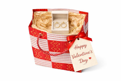 White, red, & gold mini gift bag with product ideas to gift inside on a white background