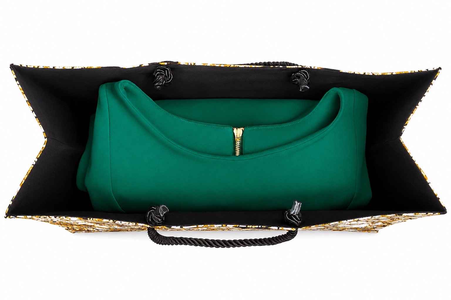 Inside view of a cream, black, and gold bag with black and gold accents and a green dress inside on a white background