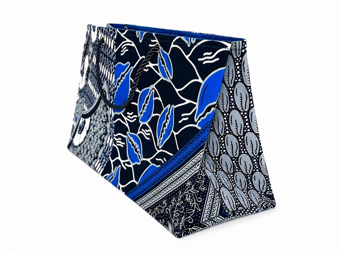 Fabric horizontal gift bag with blue, gray, and white and  pattern on a white background