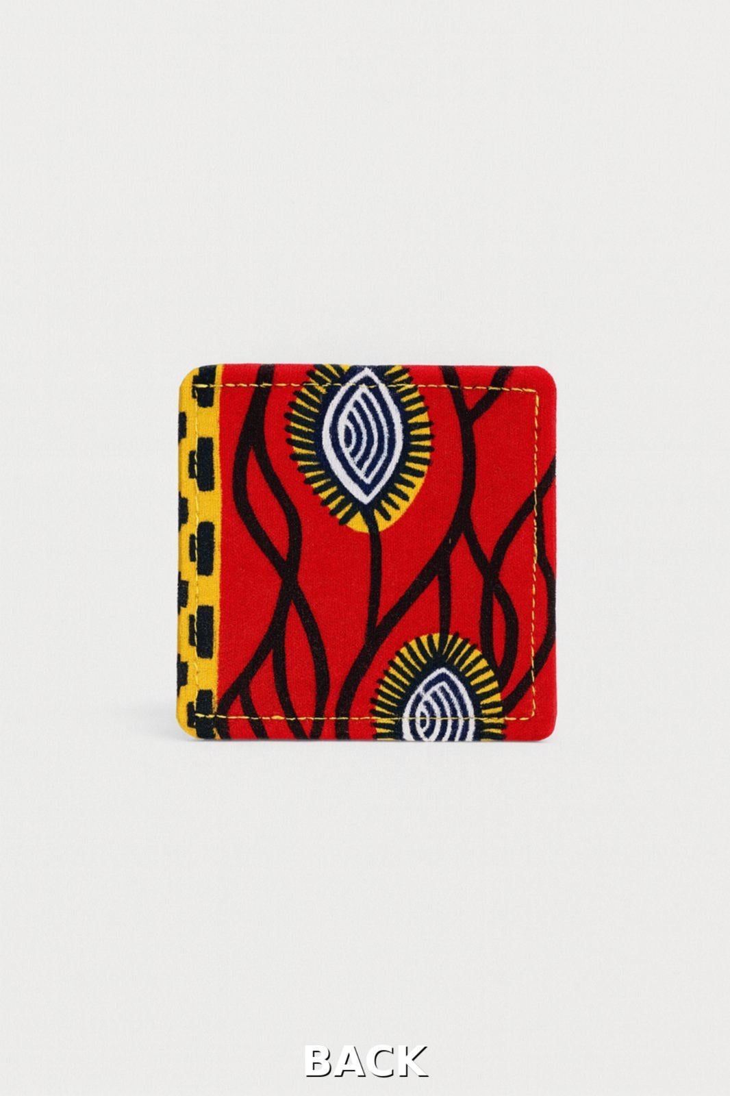 back view of corner bookmark with red, black and yellow patterns on a light gray background