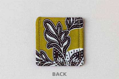 back view of green corner bookmark with  white & brown patterns on a light gray background