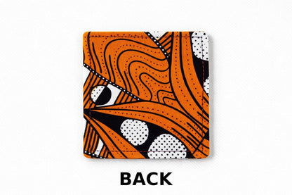 Back view of corner bookmark with orange, black, & white patterns on a light gray background