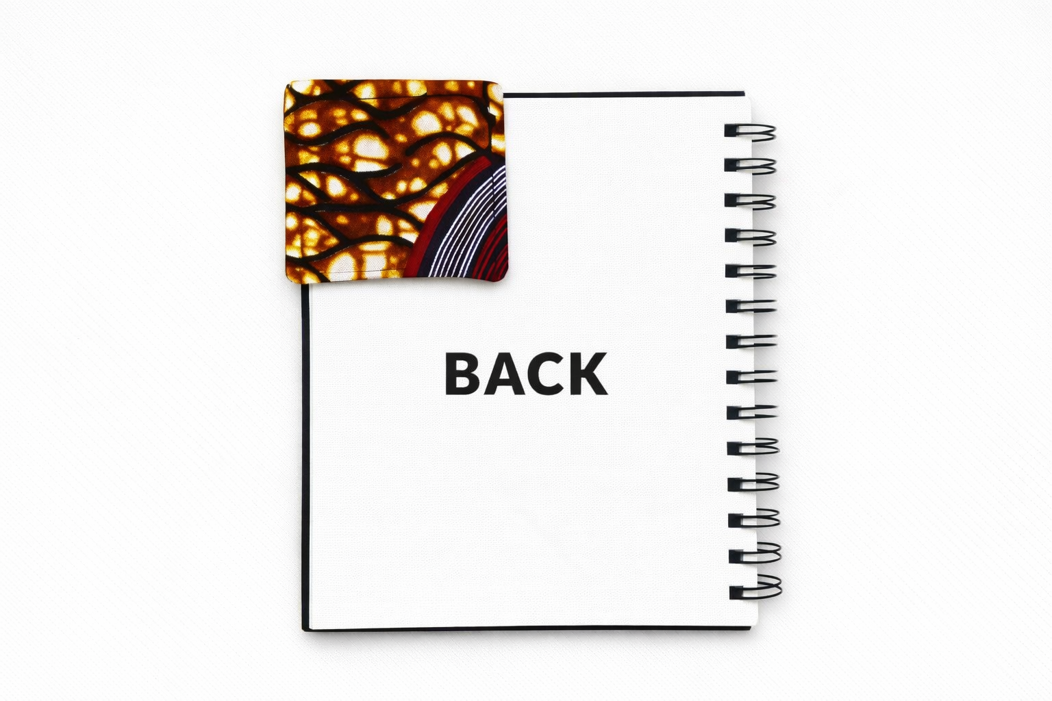 Back view of corner bookmark with brown, dark blue, maroon, & cream patterns on a light gray background