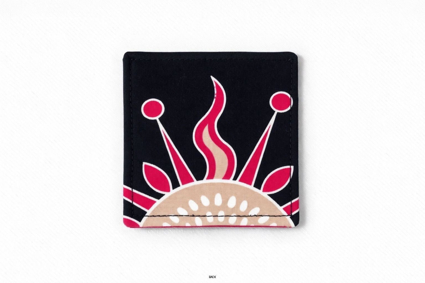 Back view of corner bookmark with black, pink, beige, & cream patterns on a light gray background