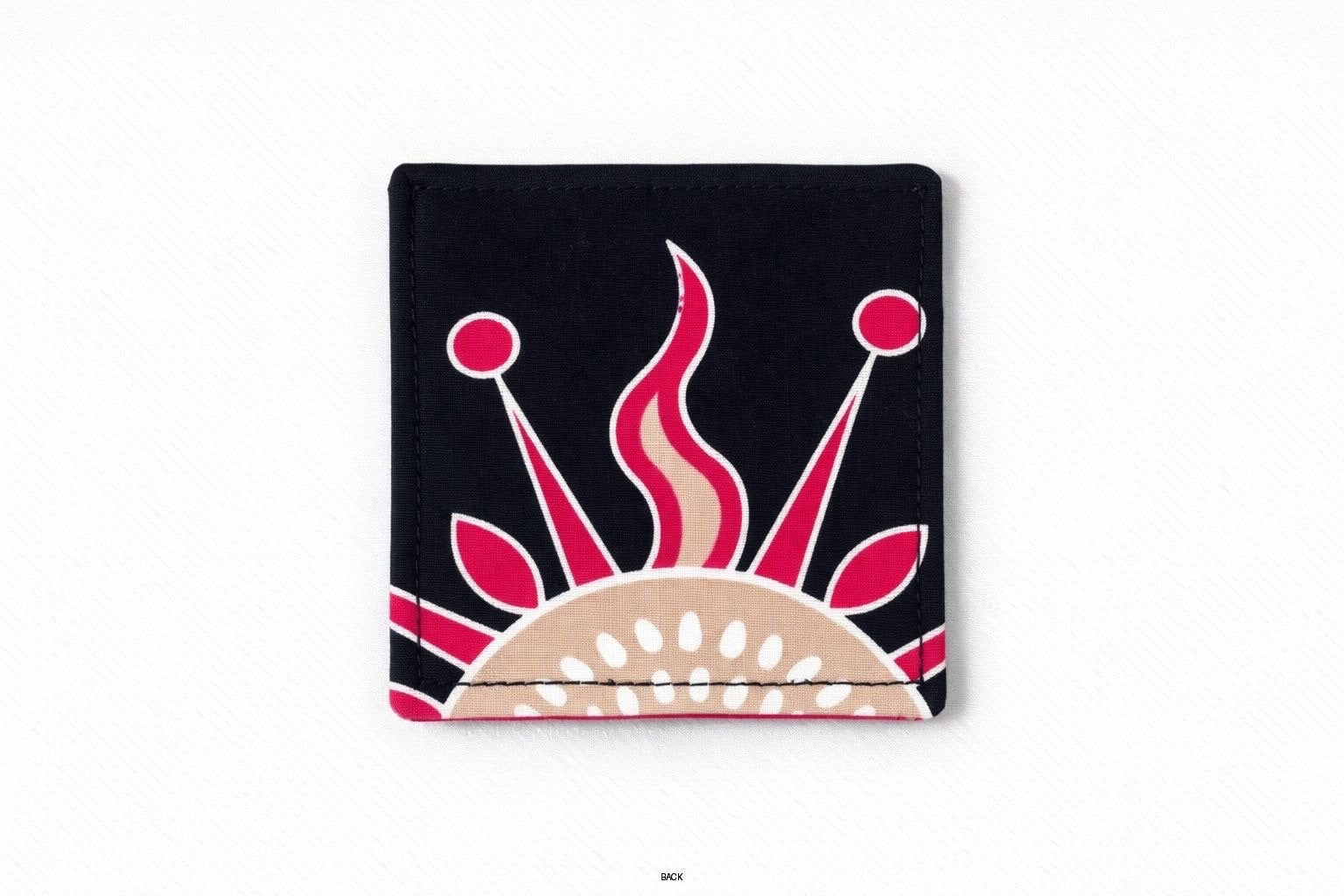 Back view of corner bookmark with black, pink, beige, & cream patterns on a light gray background