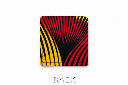 Back view of corner bookmark with black, red, & yellow patterns on a light gray background