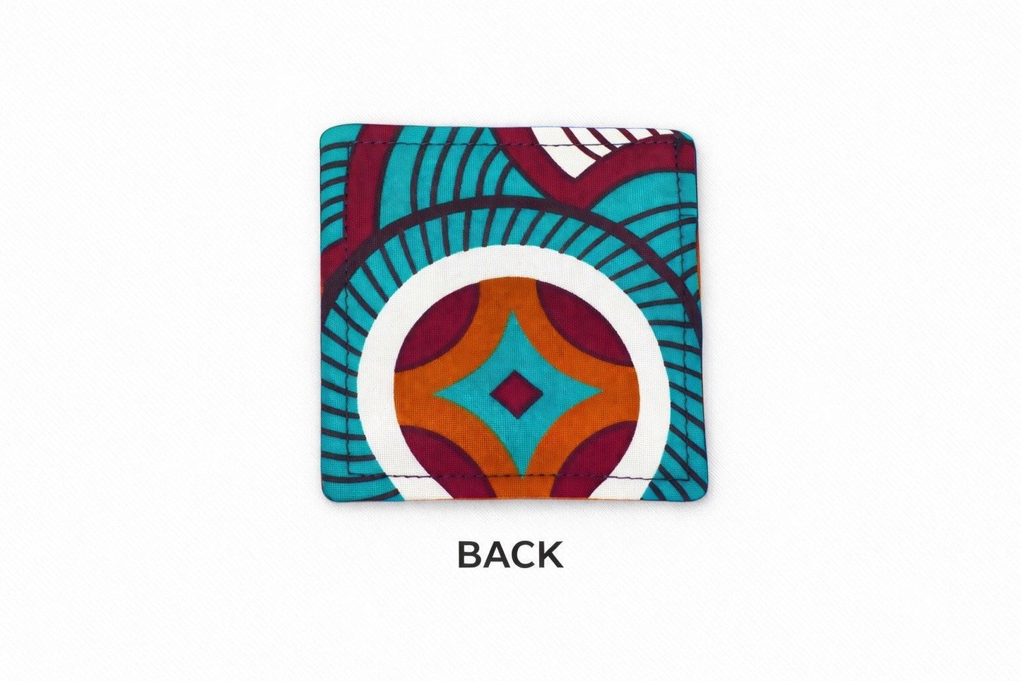 Back view of brown corner bookmark with turquoise, maroon, & white patterns on a light gray background
