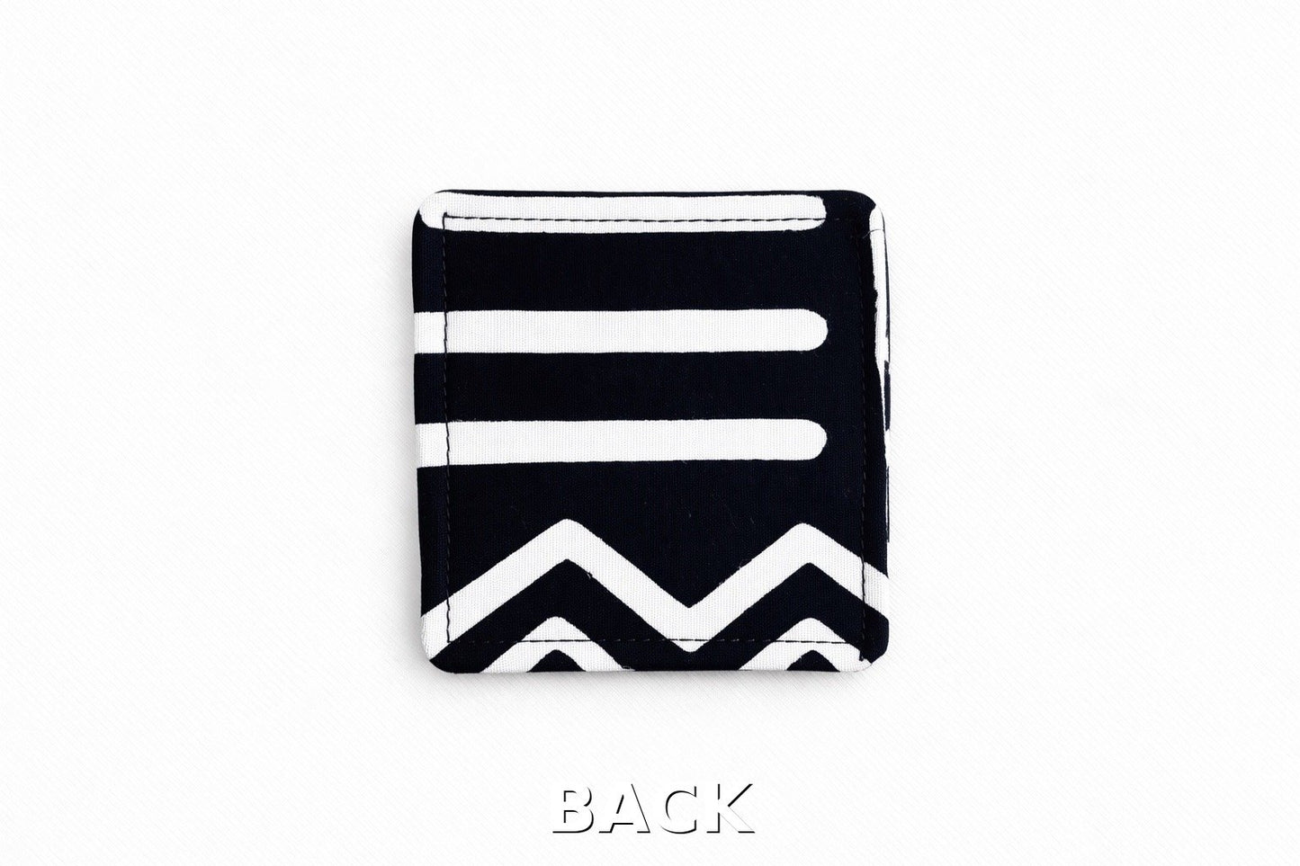 back view of black corner bookmark with white patterns on a light gray background