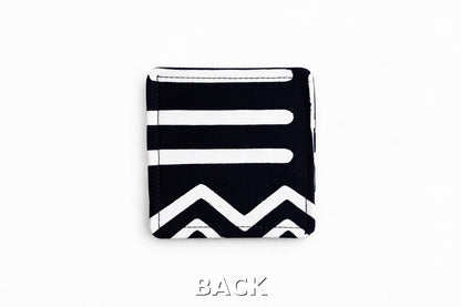 back view of black corner bookmark with white patterns on a light gray background