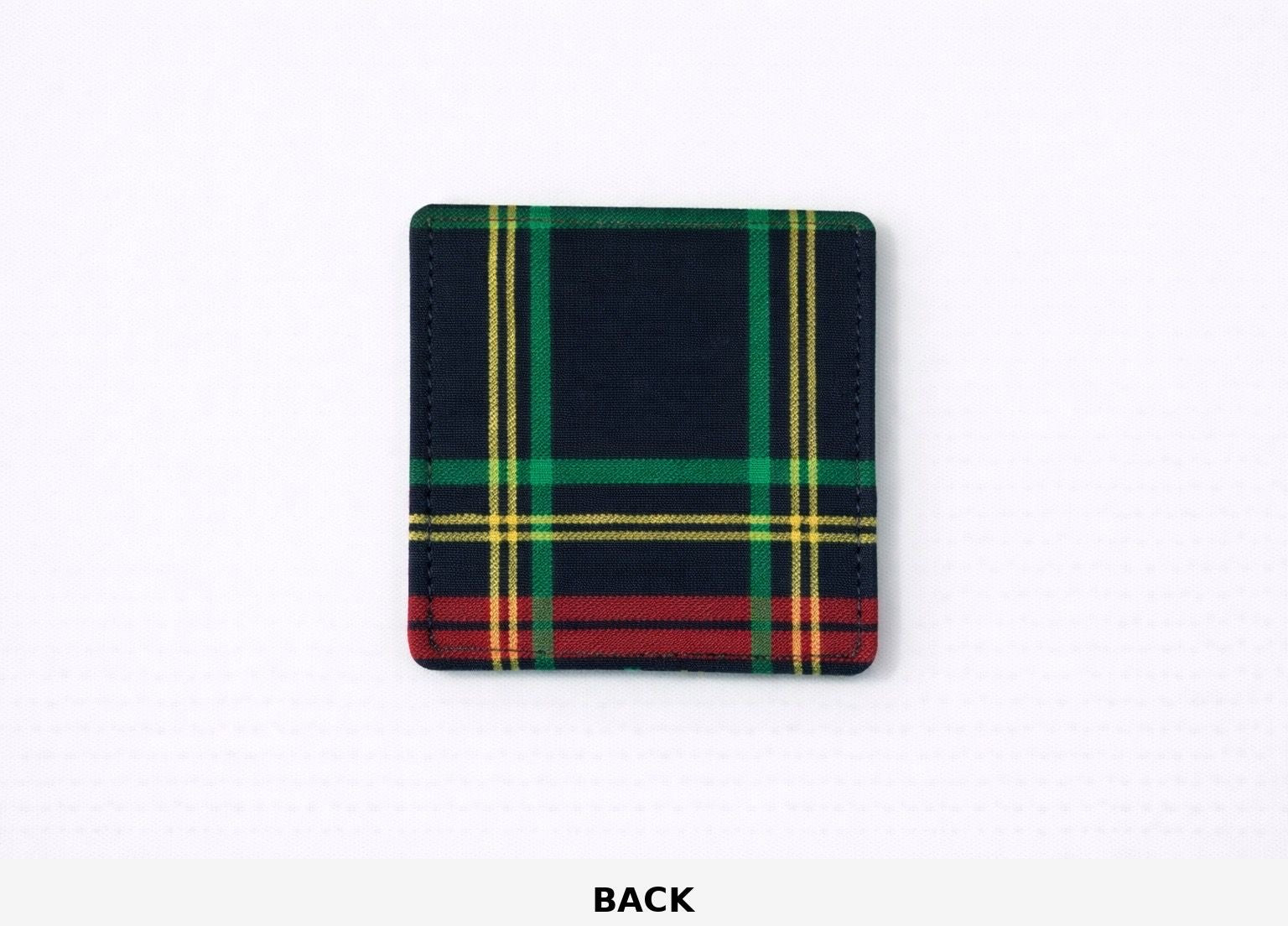 Back view of corner bookmark with black, green, red, & gold patterns on a light gray background