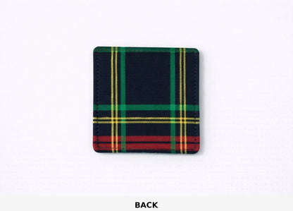Back view of corner bookmark with black, green, red, & gold patterns on a light gray background