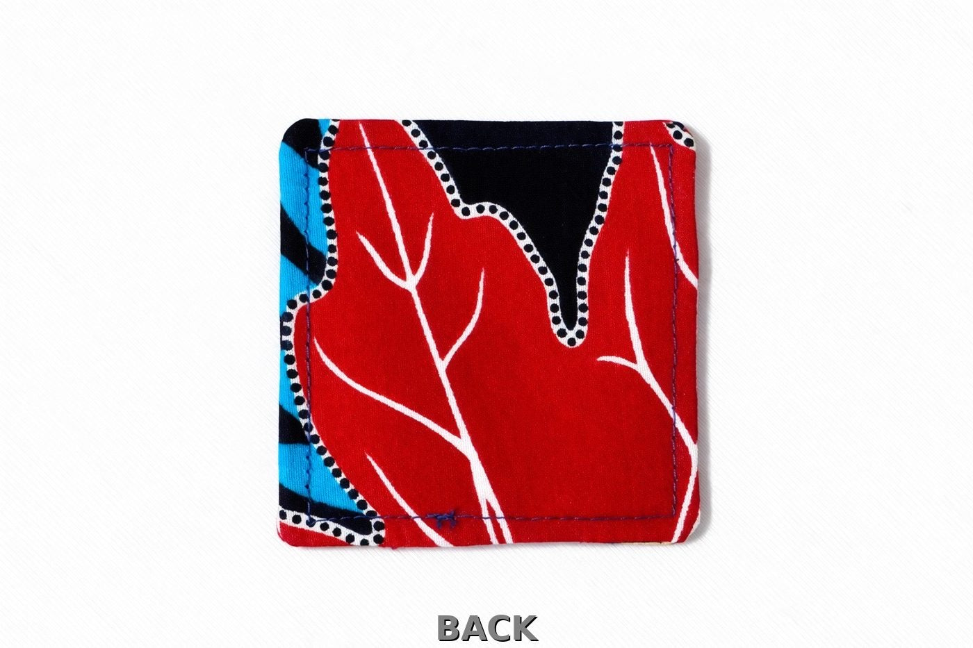 back view of corner bookmark with black, white, yellow, blue & red patterns on a light gray background