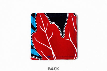 back view of corner bookmark with black, white, yellow, blue & red patterns on a light gray background