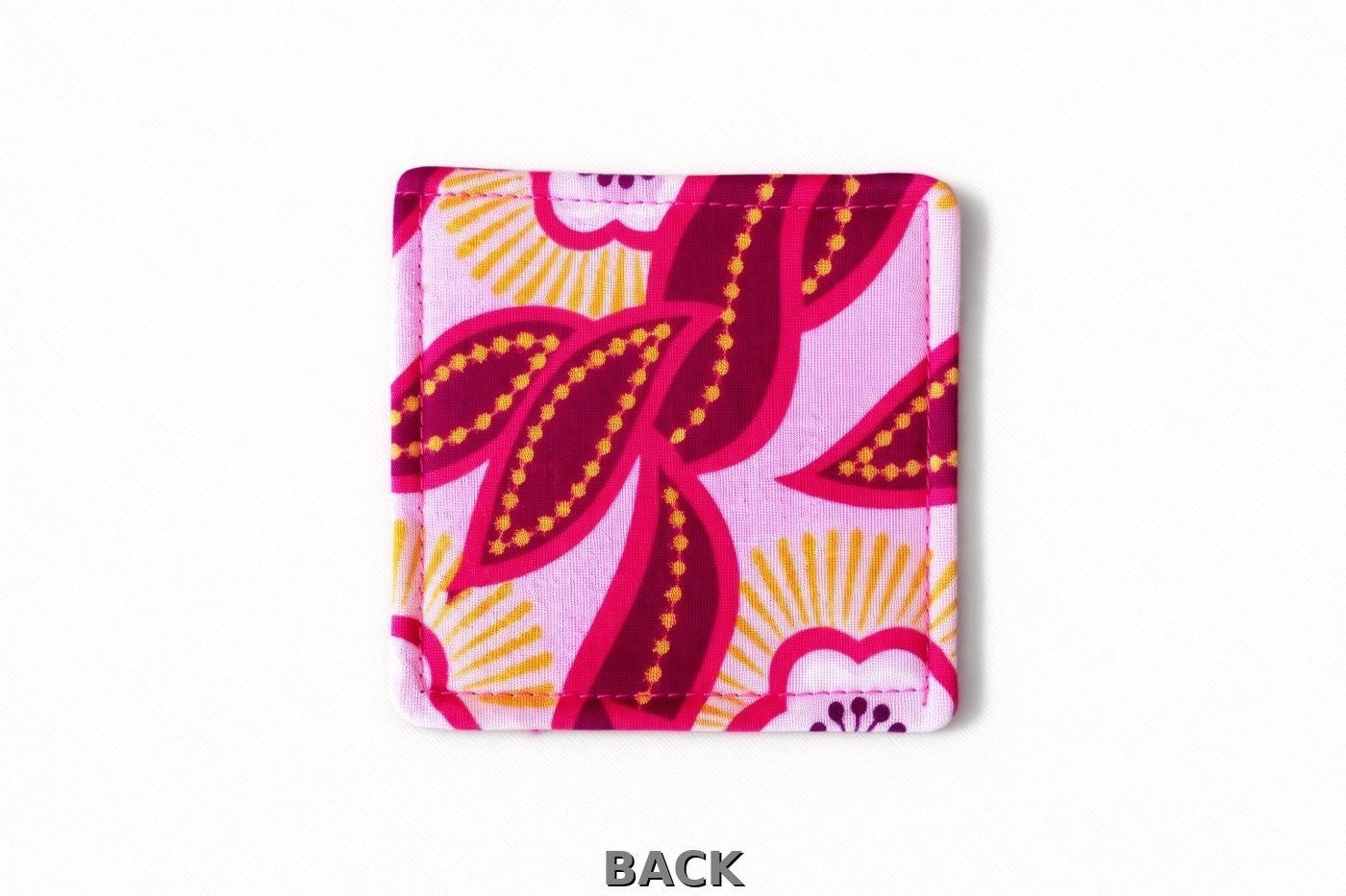back view of pink corner bookmark with dark pink, white, & gold patterns on a light gray background